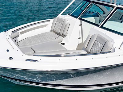 A side view of forward lounge seating on the 25’ D 246 Pursuit Luxury Dual Console Boat.