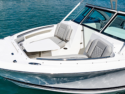 A side view of forward lounge seating on the 25’ D 246 Pursuit Luxury Dual Console Boat with removable table.