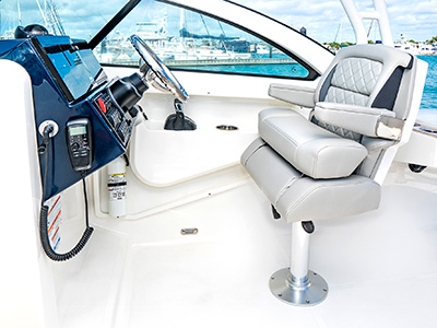 A view of adjustable helm seat with flip-up bolster on the 25’ D 246 Pursuit Luxury Dual Console Boat.
