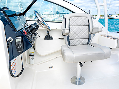 DA view of adjustable helm seat with flip-up bolster down on the 25’ D 246 Pursuit Luxury Dual Console Boat.
