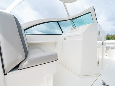 A companion seat and head door on a D 246 Pursuit Luxury Dual Console boat.