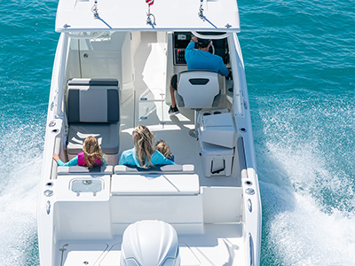 A stern angle view of D 246 Pursuit Luxury Dual Console Boat with a family onboard.