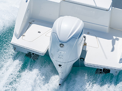 The view of a Yamaha F300 V6 offshore engine on the transom of a new D 246 Pursuit Luxury Dual Console Boat.