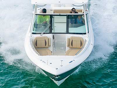 Aerial front view of family in a titanium Pursuit D 266 luxury dual console boat.