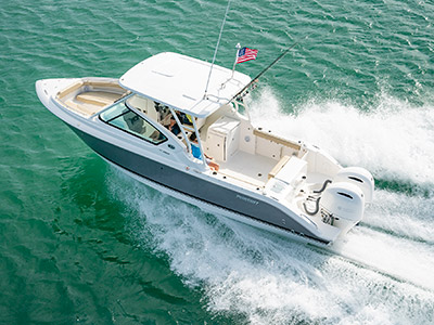 Aerial port side running shot of titanium Pursuit D 266 luxury dual console boat.