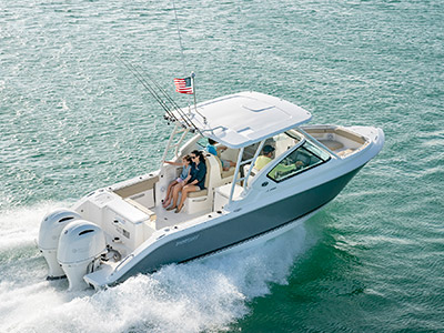 Starboard side profile shot of family in a titanium Pursuit D 266 luxury dual console boat.