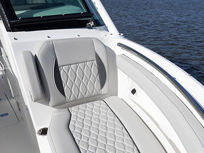 Pursuit D 266 luxury dual console boat port bow seating.