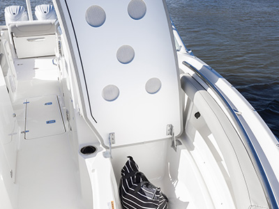 Pursuit D 266 luxury dual console boat port bow seating open to show storage.