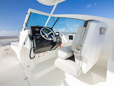 Bridge view of helm and helm seat of Pursuit D 266 luxury dual console boat.