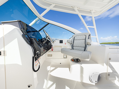 Bridge view of helm and helm seat of Pursuit D 266 luxury dual console boat.