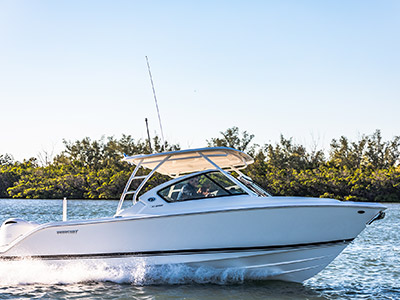 Starboard side profile shot of White Pursuit D 266 luxury dual console boat.