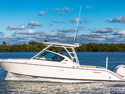 Port side profile shot of White Pursuit D 266 luxury dual console boat.