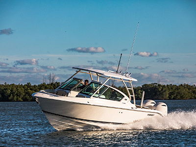 Front port side profile shot of white Pursuit D 266 luxury dual console boat.