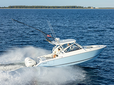 Pursuit D 286 dual console breaking waves offshore.