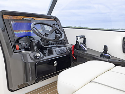 Helm with teak accents on a Pursuit D 286 Dual Console boat.