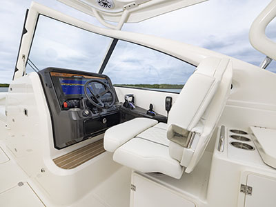 View of helm and captains chair with Garmin electronics on a Pursuit D 286 Dual Console boat.