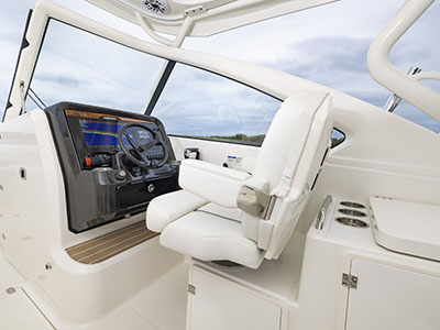View of helm and captains chair on a Pursuit D 286 Dual Console boat.