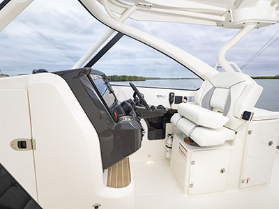 View of helm and captains chair on a Pursuit D 286 Dual Console boat.
