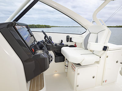 View of helm and captains chair on a Pursuit D 286 Dual Console boat.