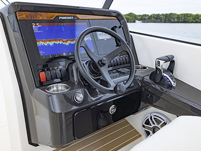 View of helm with teak accents and Garmin electronics on a Pursuit D 286 Dual Console boat.