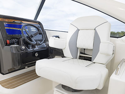 View of helm and captains chair with Garmin electronics on a Pursuit D 286 Dual Console boat.