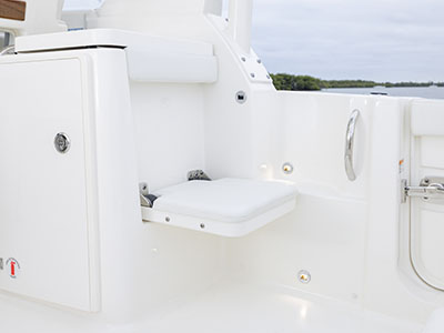 Fold out seat next to boarding door on Pursuit Boats D 286 Dual Console boat.