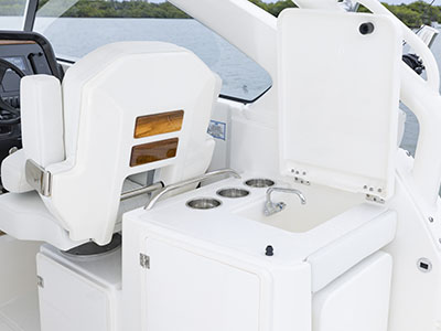 Sink, cutting board and cupholders are available in the entertainment center on a Pursuit D 286 boat.