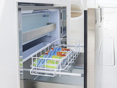 The refrigerator/freezer compartment slides open on this Pursuit D 286 Dual Console boat.