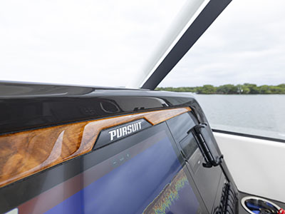 Teak accents above the Garmin electronics screen at the helm of a 28’ Pursuit Boat.