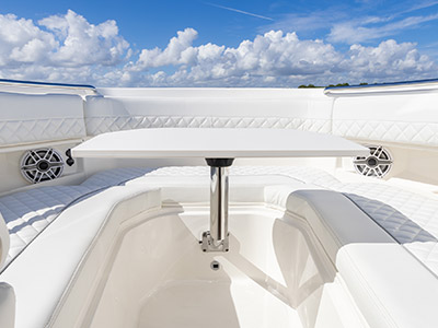 Bow seating with table on a Pursuit D 306 Luxury Dual Console boat.