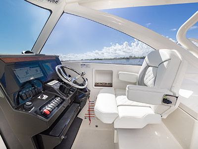 The helm with Garmin electronics on a Pursuit D 306 Luxury Dual Console boat.