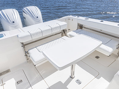 Cockpit seating with table on a Pursuit D 306 Luxury Dual Console boat.