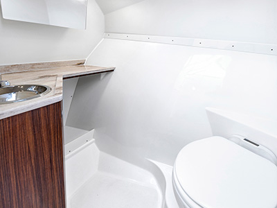 Head compartment with sink on a Pursuit D 306 Luxury Dual Console boat.