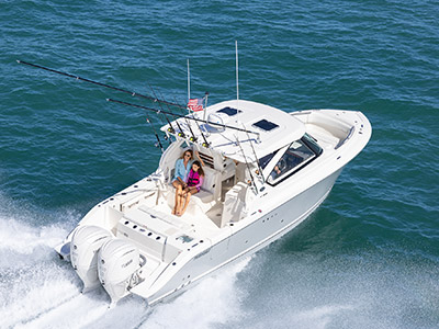 A family on a boat ride aboard a Pursuit D 306 Luxury Dual Console boat.