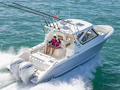 Children sit facing aft on a Pursuit D 306 Luxury Dual Console.