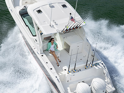 Woman sits in aft facing seat on a Pursuit Boat