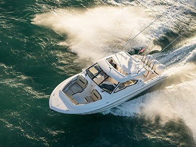 Aerial front one quarter view of white Pursuit D 365 luxury dual console boat.