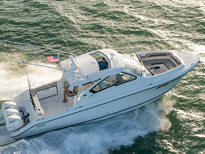 Aerial profile view of white Pursuit D 365 luxury dual console boat one of our cabin cruiser fishing boats.