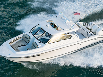 Aerial front one quarter view of white Pursuit D 365 luxury dual console boat.