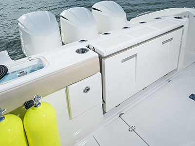 Pursuit D 365 luxury dual console boat transom with 3 engines.