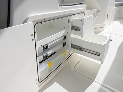 Cockpit tackle storage of Pursuit DC 266 luxury dual console boat.