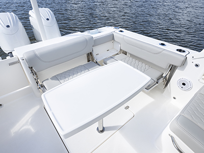 Cockpit seating with table on a Pursuit DC 266 Luxury Dual Console boat.