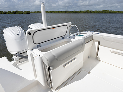Aerial view of transom storage and fish box lids open of Pursuit DC 266 luxury dual console boat.