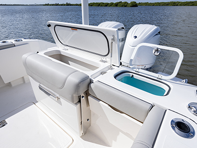 Aerial view of transom storage and fish box lids open of Pursuit DC 266 luxury dual console boat.