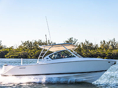 Starboard side profile shot of White Pursuit DC 266 dual console boat.
