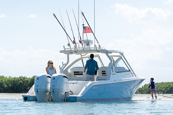 A family enjoys the sandbar on a Pursuit Dual Console Boat.