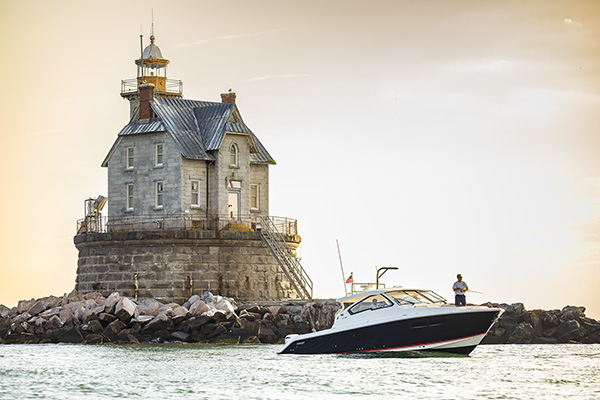 The Pursuit DC 365 in front of the Race Rock Lighthouse in golden hours.