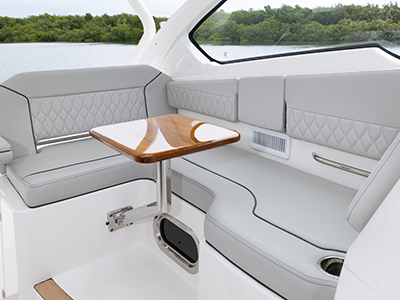Pursuit DC 365 luxury dual console boat forward seating with stoable table.