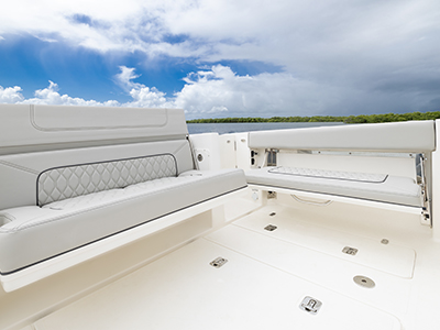 Pursuit DC 365 luxury dual console boat cockpit social zone with seats down.