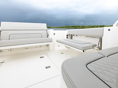 Pursuit DC 365 luxury dual console boat cockpit social zone with seats down.